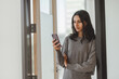 © Maria Vitkovska - Portrait of confident indian business woman wearing casual clothes holding smartphone