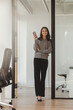 © Maria Vitkovska - Portrait of beautiful smiling businesswoman wearing casual wear, holding phone