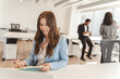 © Maria Vitkovska - Portrait of smiling american woman wearing formal clothes, taking notes in modern office