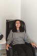 © Maria Vitkovska - Indian businesswoman takes short time-out in office work. Beautiful lady lying relaxed in massage chair. Female entrepreneur resting at workplace. Comfortable office furniture
