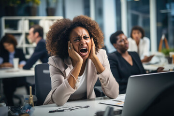 Wall Mural - Stressed Black Woman Sitting at a Desk, Clearly Annoyed and Frustrated in Her Office Environment
