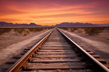 Travel Concept. Railroad Track With Beautiful Desert Landscape. Mountain View At Classic Sunset Background. Transportation And Sky