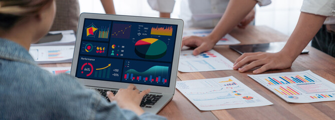Fototapete - Panorama shot analyst team utilizing BI Fintech to analyze financial report with laptop. Businesspeople analyzing BI power dashboard displayed on laptop screen for business insight. Scrutinize