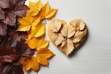 Autumn Composition Heart And Maple Leaves On White Wooden Background. Generative AI