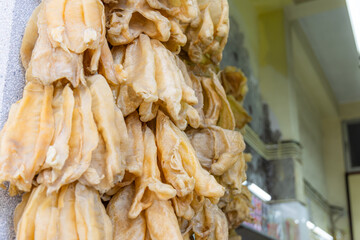 Poster - Dry fish maw hanging at the store for selling