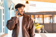 © luismolinero - Handsome Arab man at outdoors keeping a conversation with the mobile phone with someone