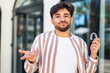 © luismolinero - Handsome Arab man holding invisible braces at outdoors making doubts gesture while lifting the shoulders