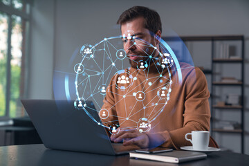 Wall Mural - thoughtful businessman in casual wear typing on laptop at office workplace. concept of distant work,