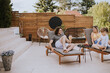 © BGStock72 - Family with a mother, father and daughter sitting on the deck chairs by the swimming pool