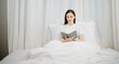 © laddawan - Portrait of Good Healthy young woman reading book and resting in bed at bedroom.  in morning lifestyle concept.