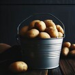 Side view potatoes in gray bucket on dark wooden background. horizontal