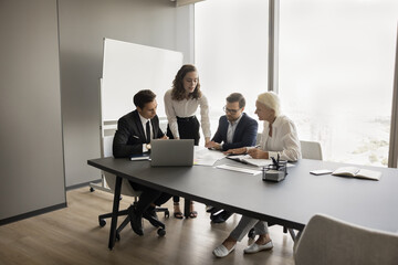 Poster - Speaker woman presenting idea for brainstorming, work project, using showing online content, paper reports, speaking to colleagues at meeting table. Business teacher, coach training employees