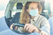 © ADDICTIVE STOCK CORE - Crop woman in face mask driving modern car in city