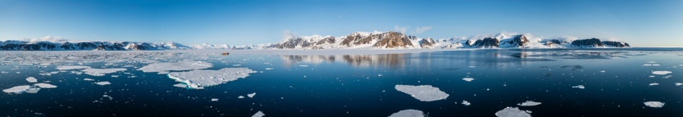 Drone shot of a ship in a bay in Svalbard