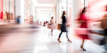 Blurred Background Of A Modern Shopping Mall With Some Shoppers. Stylish Women  Looking At Showcase, Motion Blur. Abstract Motion Blurred Shoppers With Shopping Bags
