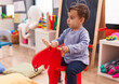 © Krakenimages.com - Adorable hispanic boy playing with reindeer rocking at kindergarten