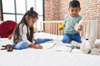 © Krakenimages.com - Adorable boy and girl drawing on notebook playing with duck toy at bedroom