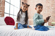 © Krakenimages.com - Adorable boy and girl smiling confident holding teddy bear at bedroom