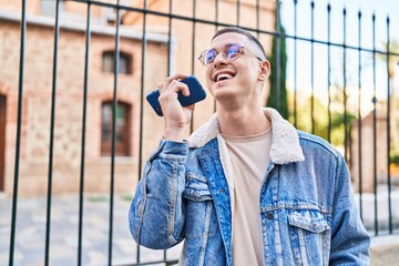 Poster - Young hispanic man smiling confident talking on the smartphone at street