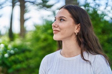 Wall Mural - Young woman smiling confident looking to the side at park