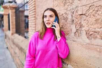 Wall Mural - Young woman smiling confident talking on the smartphone at street