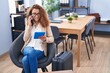 © Krakenimages.com - Young beautiful hispanic woman business worker waiting for travel talking on smartphone at office