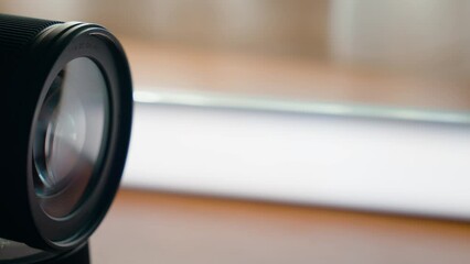 Wall Mural - Close-up shot of a mirrorless camera lens on a desk.