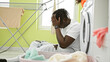 © Krakenimages.com - African american man waiting for washing machine stressed at laundry room