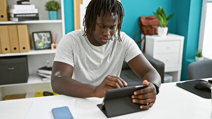 Sticker - African american man business worker writing on touchpad working at the office