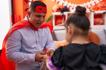 Wall Mural - Hispanic man and girl having halloween party at home