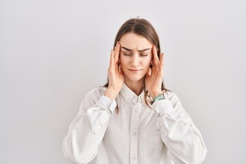 Poster - Young caucasian woman standing over isolated background with hand on head, headache because stress. suffering migraine.