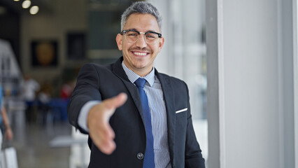 Sticker - Young hispanic man business worker smiling confident shake hand at office