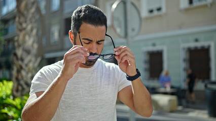 Sticker - Young hispanic man wearing glasses at street