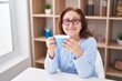 © Krakenimages.com - Senior woman drinking coffee sitting on table at home