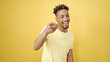 African american man smiling confident pointing with fingers to the camera over isolated yellow background