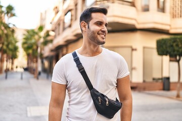 Wall Mural - Young hispanic man smiling confident standing at street