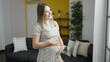 © Krakenimages.com - Young pregnant woman smiling confident touching belly at home