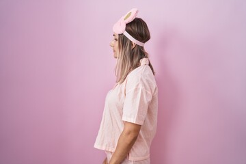 Canvas Print - Blonde caucasian woman wearing sleep mask and pajama looking to side, relax profile pose with natural face and confident smile.