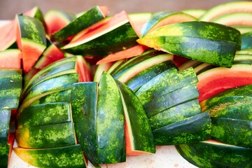 Wall Mural - watermelon sliced on a white board next to a spoon