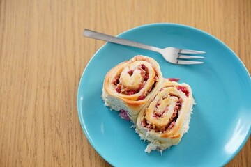 Appetizing plate with two fluffy homemade rhubarb cake rolls