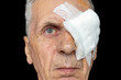 © fotosenukas - An adult man's eye is covered with white gauze after surgery