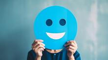 Woman Holding Blue Paper Cut Happy Smile Face, Positive Thinking, Mental Health Assessment , World Mental Health Day Concept