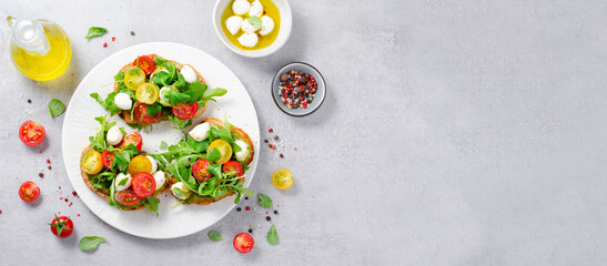 Wall Mural - Bruschetta with Cherry Tomatoes, Mini Mozzarella Cheese and Pesto Sauce, Caprese Toasts