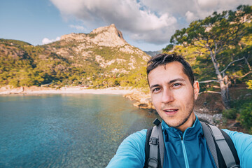 Wall Mural - Happy man taking selfie admiring view of a scenic sea coast. Lycian Way travel sights