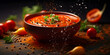 Spicy tomato soup in a bowl with pepper corns