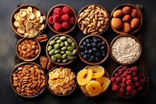 Healthy Snack. Healthy Eating Concept. Assortment Of Nuts And Dried Fruits In Bowls On Black Background.