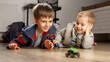 Portrait of two little boys playing with toys on wooden floor in bedroom. Children playing alone, development and education, games at home.