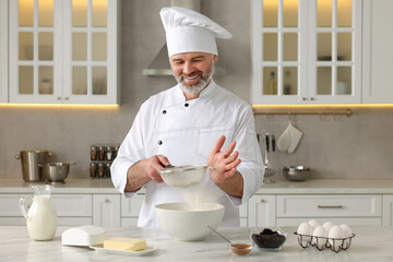 Wall Mural - Professional chef making dough at white marble table in kitchen