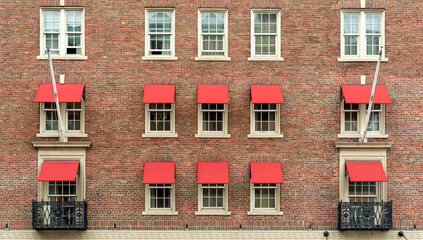 Wall Mural - Old brick residential building facade with red window awnings, Boston, Massachusetts, USA