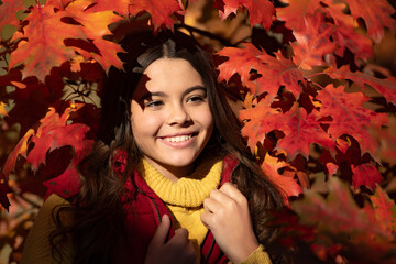 Canvas Print - Autumn teen child portrait. happy kid standing at beautiful autumn leaves. fall season